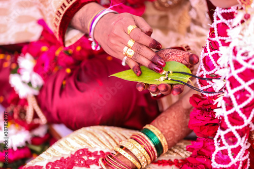 Traditional indian wedding ceremony: Mangalsutr with green leaf holding in hand