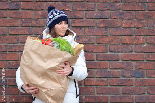 Woman with groceries package near grocery store photo