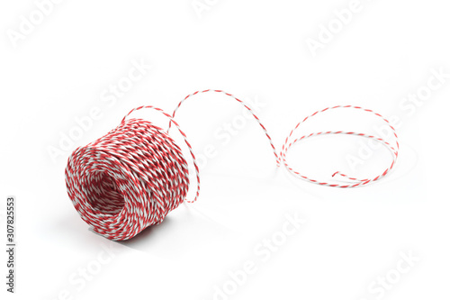 Obraz na plátně Red and white bakers twine rope spool isolated on white background