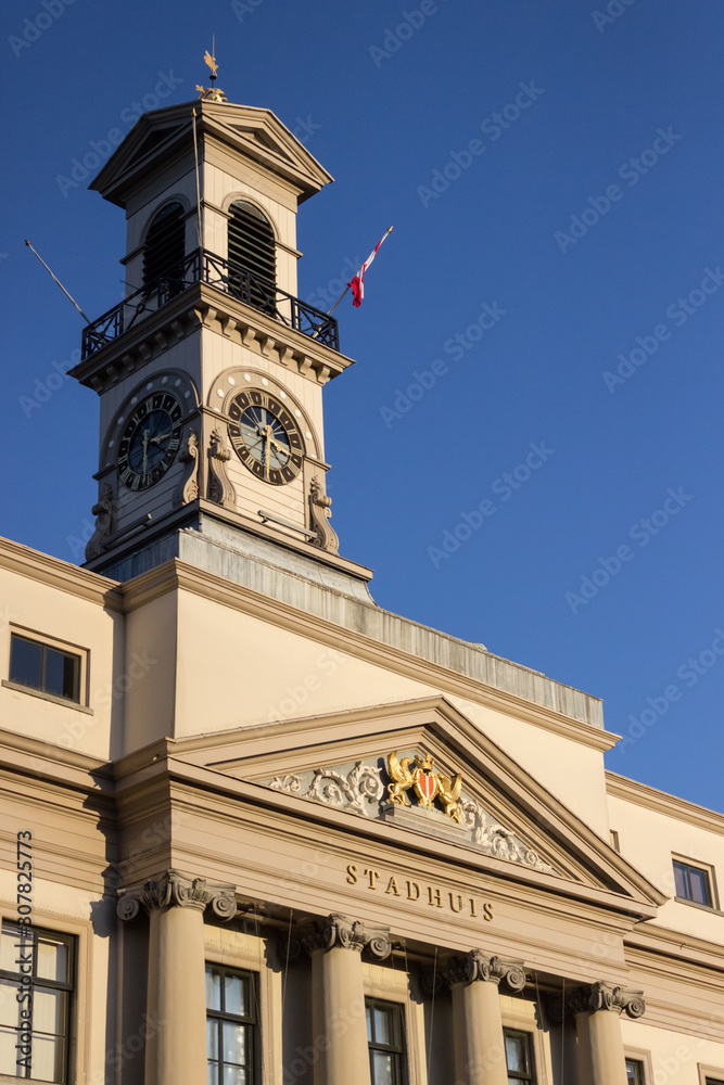 Clock tower of the city hall (stadhuis in Dutch) of the Dutch city Dordrecht on a clear blue sky day, the Netherlands