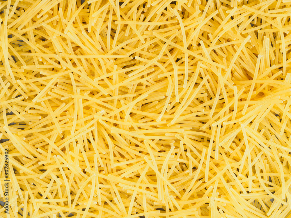 Background of little yellow pasta. Healthy eating concept