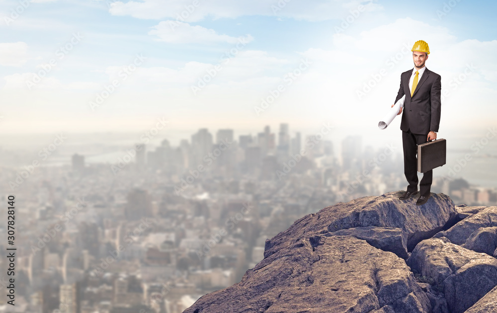 Young business person looking to the city from distance Young business person looking to the city from distance