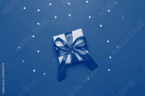 Wrapped present or giftbox toned in color of the year 2020 classic blue, top view