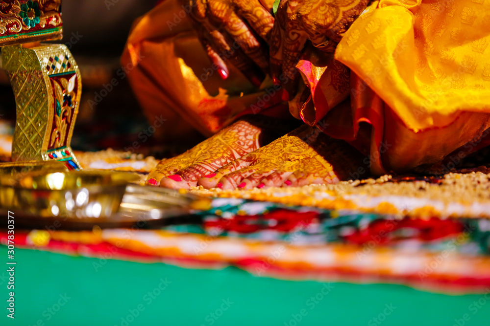 Fototapeta premium Traditional indian wedding ceremony, groom holding hand in bride hand