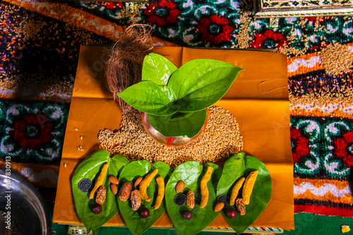 Indian wedding ceremony : decorative coper kalash with green leaf and coconut 