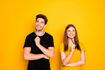 Photo of cheerful positive cute nice charming couple of two people pondering over surprise for each other isolated over vivid color background in black t-shirt