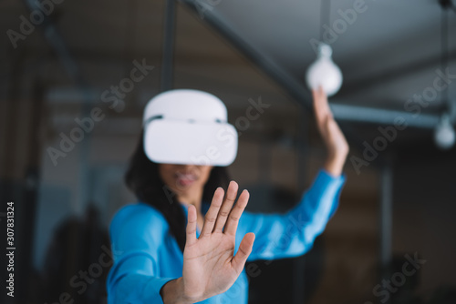 Woman in VR goggles looking at hand