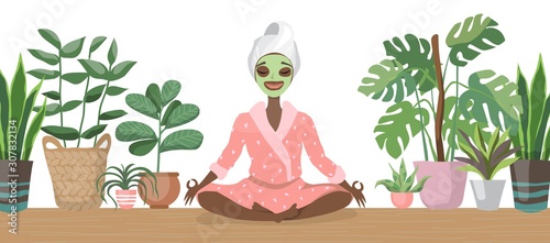 Beautiful young black african american woman with facial mask on her face relax at home