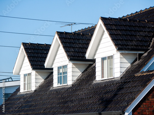 Canvastavla Attic windows on the black tile roof of residential house