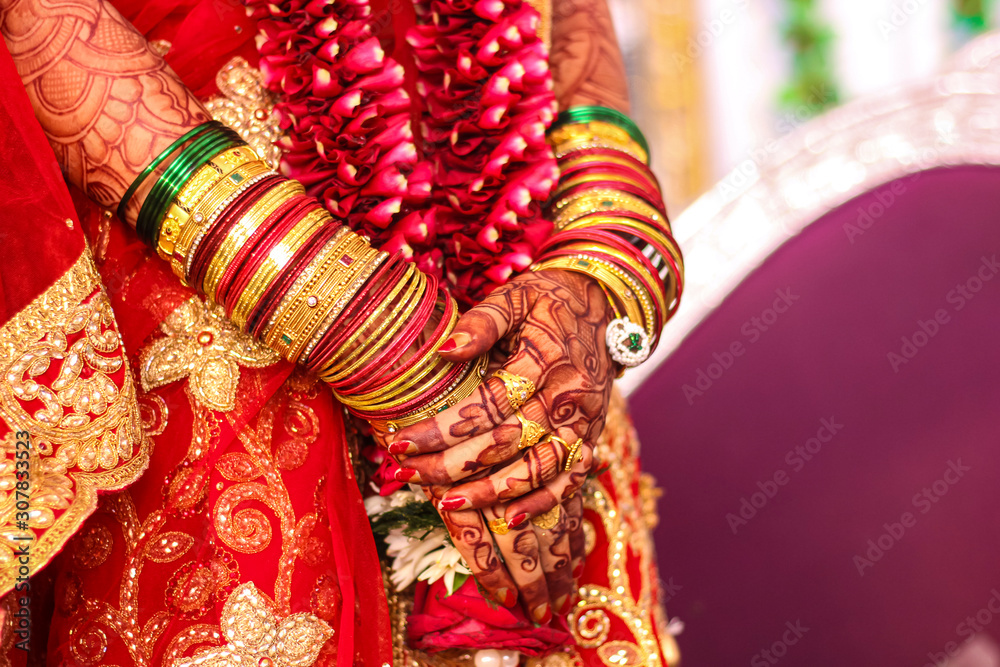 Beautiful Indian bride hand with mehandi design and jewelry 