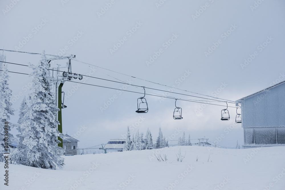 Winter landscape in Sheregesh. Funicular for tourists, skiers and snowboarders. lift to transport people in the mountains. the cable car on the background of blue mountains. funicular in the mountains Winter landscape in Sheregesh. Funicular for tourists, skiers and snowboarders. lift to transport people in the mountains. the cable car on the background of blue mountains. funicular in the mountains