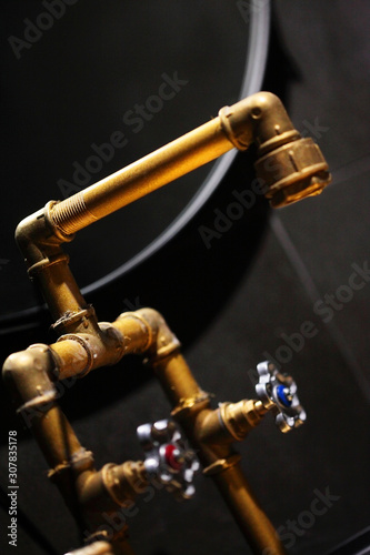 Golden, copper faucet loft style.Copper wash bassin.Creative design.Selective focus