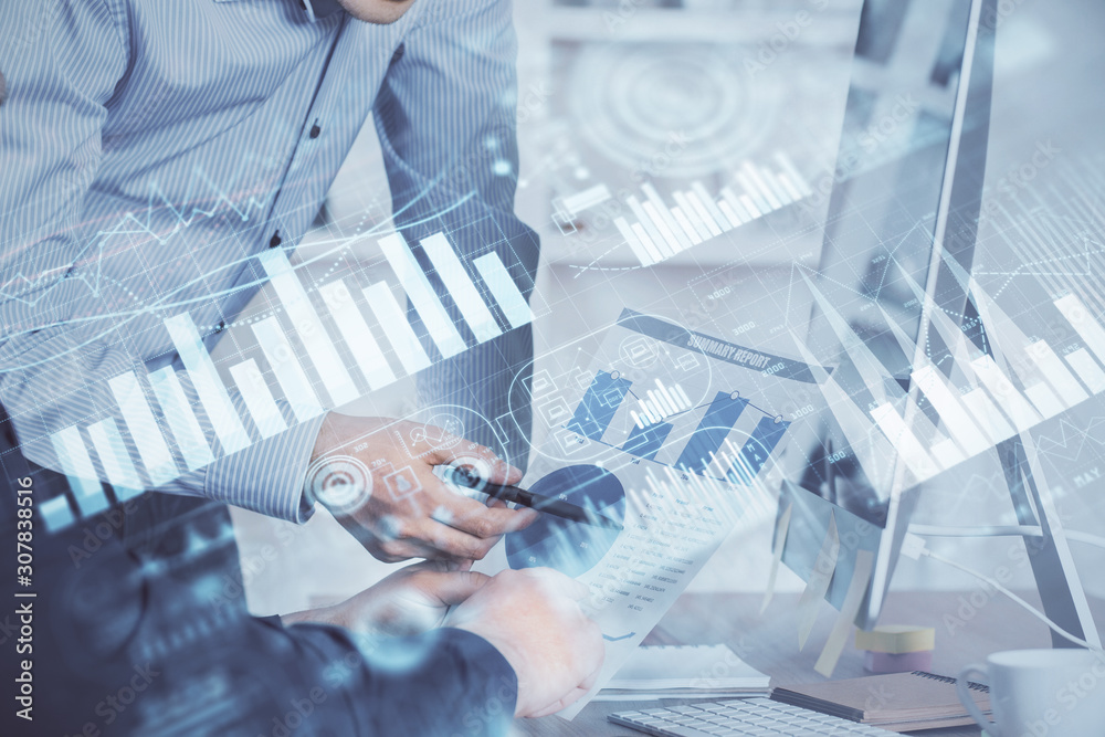 Double exposure of chart with businessman typing on computer in office on background. Concept of hard work. Double exposure of chart with businessman typing on computer in office on background. Concept of hard work.