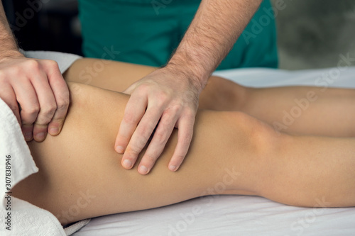 Hands of a masseur's man doing a massage of the abdomen.
