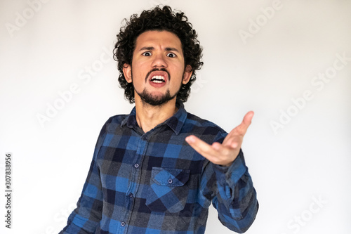 Latin American man, angry upset expression, pointing manner