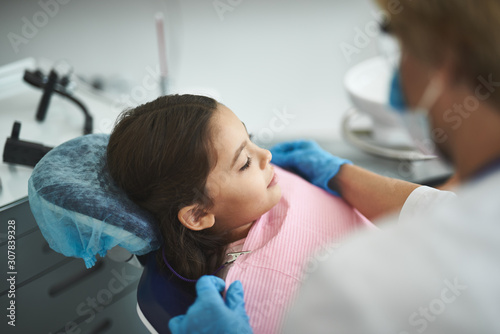 Close up of a nice girl sitting in the dentistry