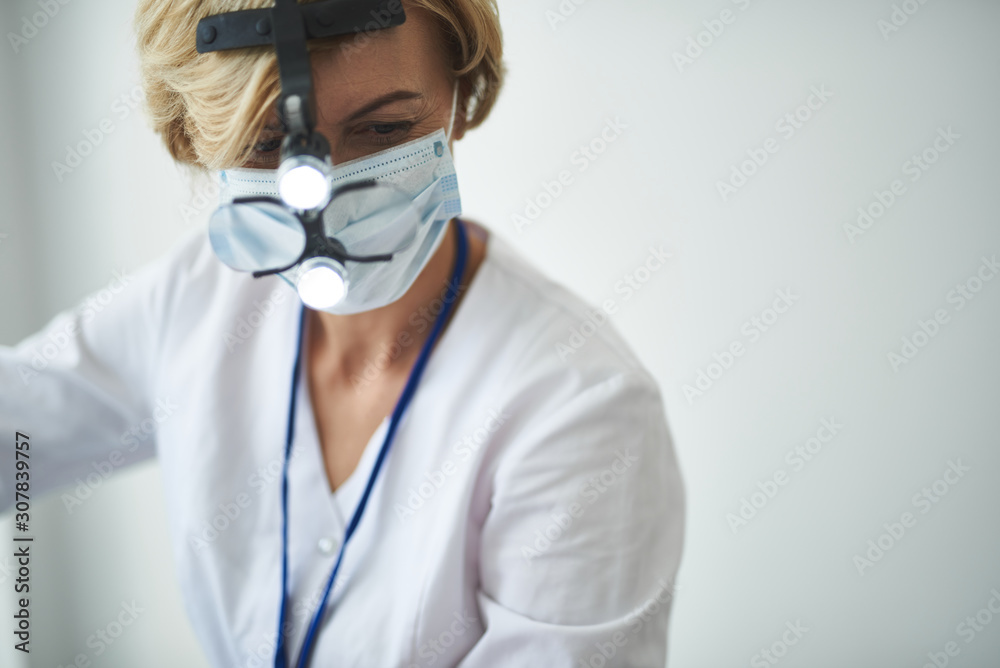 Female dentist is working with special equipment Female dentist is working with special equipment