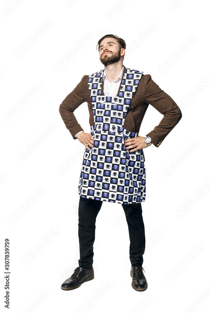 Young attractive man in a businessman suit and home apron for cleaning, smiles put his hands on his hips. Isolated on a white background. Young attractive man in a businessman suit and home apron for cleaning, smiles put his hands on his hips. Isolated on a white background.