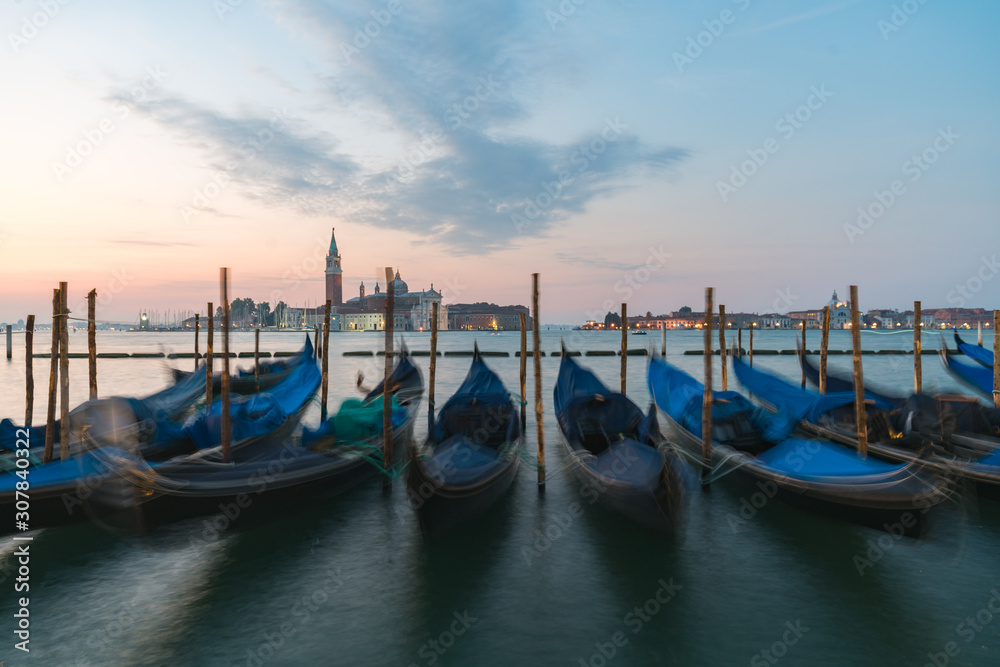 Sunrise of Venice Grand Canal with gondola in foreground on the sea
