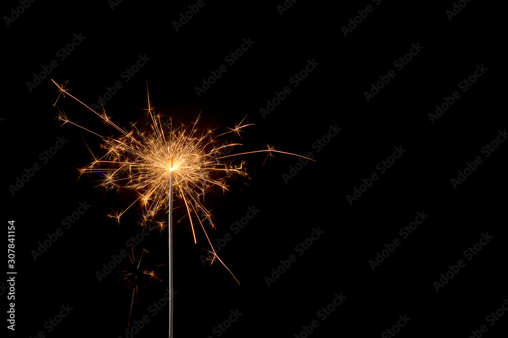 burning sparkler on a black background