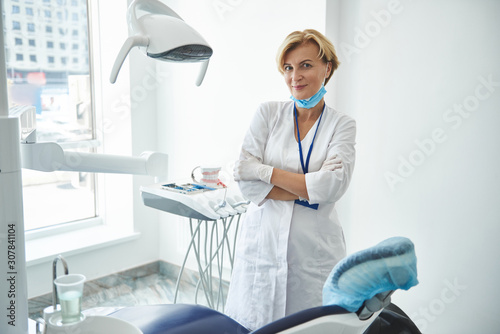 Joyful adult dentist is relaxing after appointment