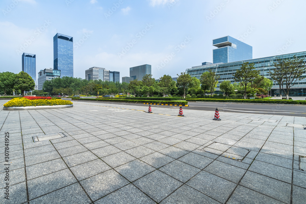 Fototapeta premium empty tiled floor before city skyline and cityscape.