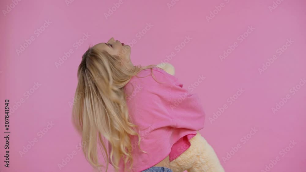 smiling woman dancing with teddy bear isolated on pink smiling woman dancing with teddy bear isolated on pink