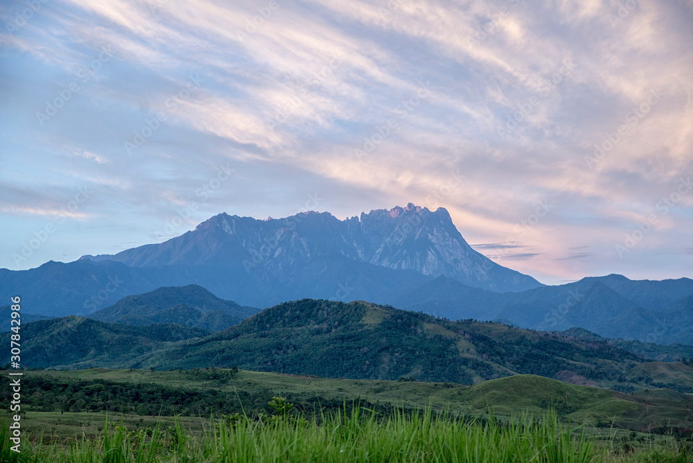 The majestic Mount Kinabalu peak highlighted when dawn's breaking. A view from Lasau Podi plains in Kota Belud.
