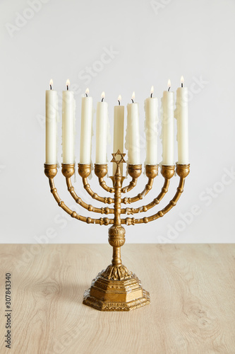 burning candles in menorah on Hanukkah isolated on white