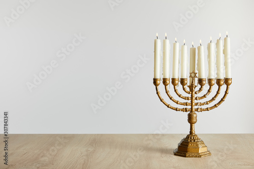 burning candles in menorah on Hanukkah isolated on white photo