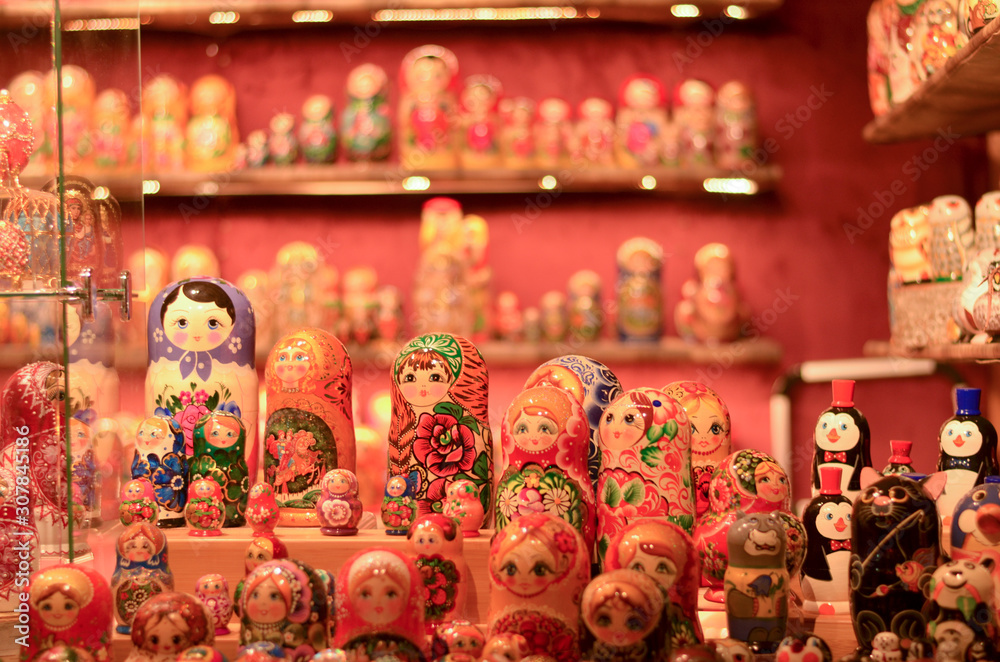 Russian doll art or Matryoshka kept on a store front in a European Christmas market. Also known as Babushka, stacking, nesting dolls or tea dolls are decreasing in size kept inside each other