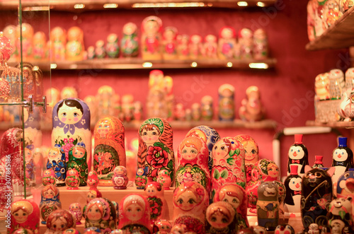 Russian doll art or Matryoshka kept on a store front in a European Christmas market. Also known as Babushka, stacking, nesting dolls or tea dolls are decreasing in size kept inside each other © PhotographrIncognito