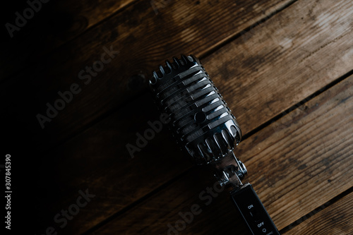 Retro microphone on dark wooden background