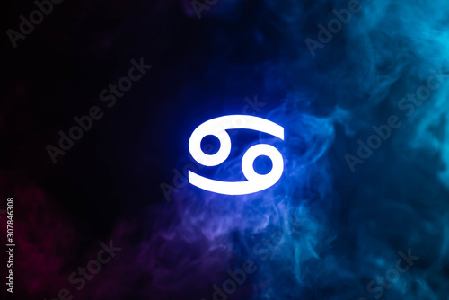 Quadro su tela blue illuminated Cancer zodiac sign with smoke on background