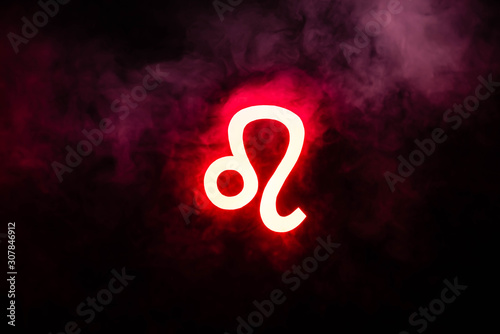 red illuminated Leo zodiac sign with smoke on background photo