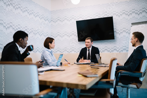 Businesspeople having formal discussion in office