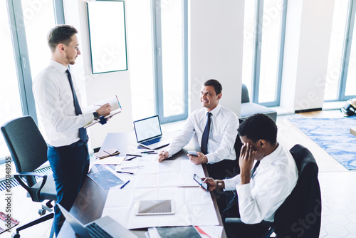 Elegant adult diverse businessmen during negotiation in office