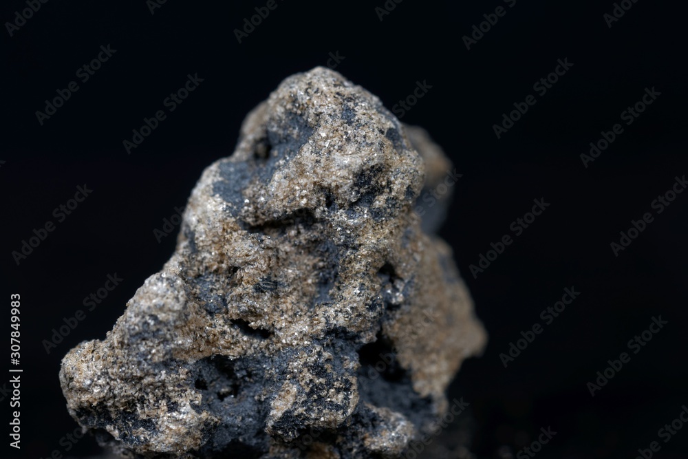 Calcium carbide or calcium acetylide with a black background Calcium carbide or calcium acetylide with a black background