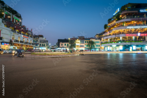 Dong Kinh Nghia Thuc Square in the Old Quarter of Hanoi, Vietnam at twilight. Street with copyspace and blurred buildings on background photo