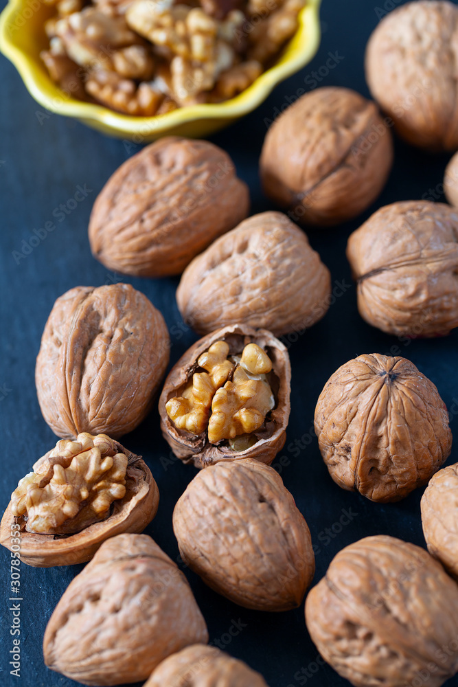 walnuts on black stone surface walnuts on black stone surface