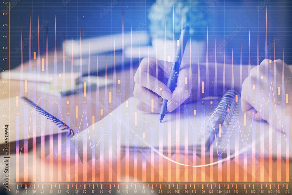 Financial forex graph drawn over hands taking notes background. Concept of research. Multi exposure Financial forex graph drawn over hands taking notes background. Concept of research. Multi exposure