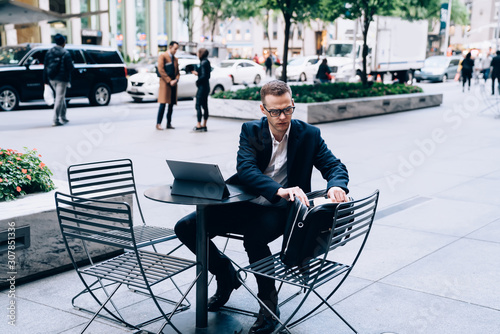 Businessman working seriously in street cafe