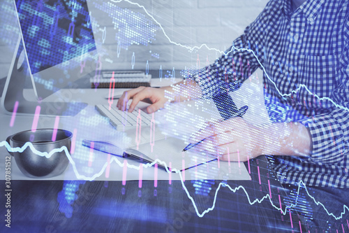 Double exposure of stock market chart with man working on computer on background. Concept of financial analysis.