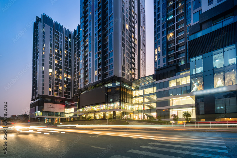 Hanoi cityscape at twilight with asphalt road and modern buildings on background