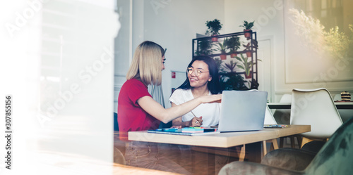 Content woman using laptop for freelance work with partner