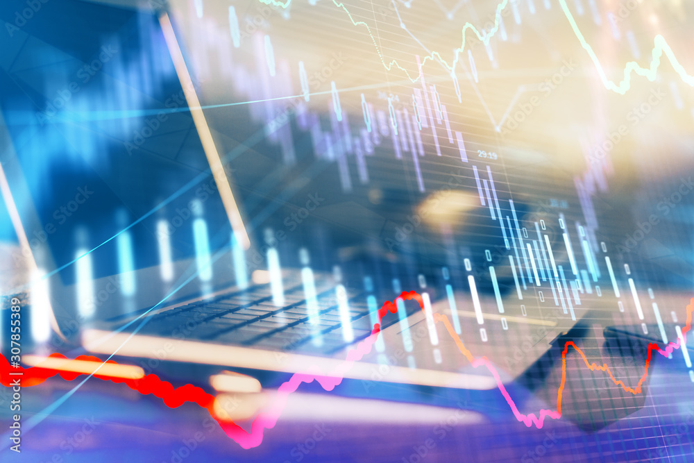 Financial graph colorful drawing and table with computer on background. Double exposure. Concept of international markets. Financial graph colorful drawing and table with computer on background. Double exposure. Concept of international markets.