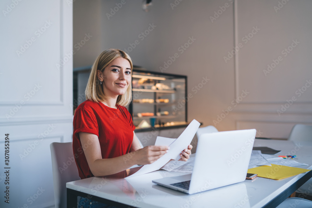 Happy young woman browsing documents in cafe Happy young woman browsing documents in cafe