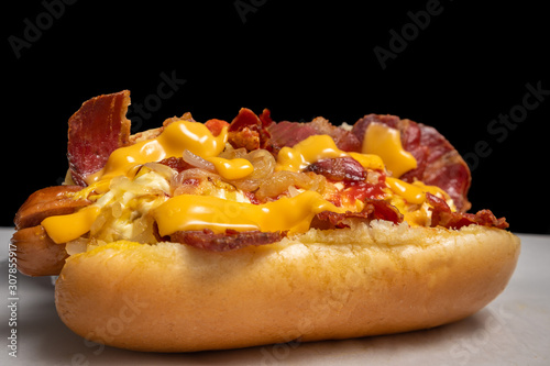 yummy hotdog with cheddar cheese and fried bacon