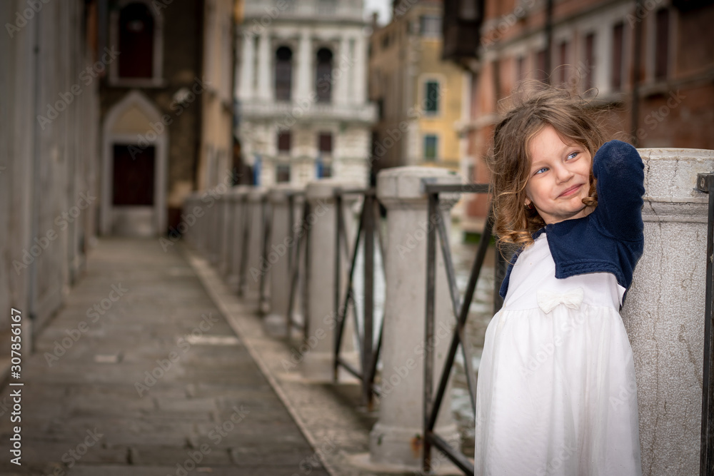 cute little girl near a water canal in Venice italy