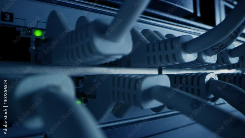 Macro Shot: Ethernet Cables Connected to Router Ports with Blinking Lights. Telecommunications: RJ45 Internet Connectors Plugged into Modem LAN Switches. Side View Moving Camera Macro Shot: Ethernet Cables Connected to Router Ports with Blinking Lights. Telecommunications: RJ45 Internet Connectors Plugged into Modem LAN Switches. Side View Moving Camera